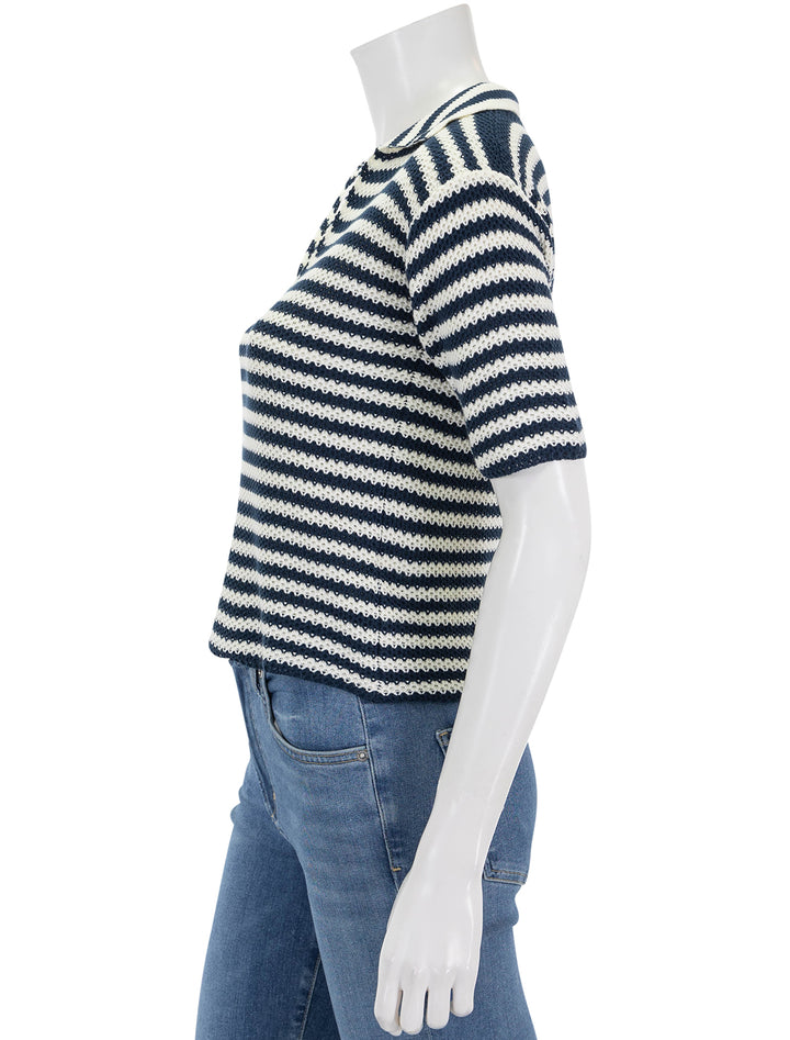 Side view of KULE's the lucie knit polo in cream and navy stripe.