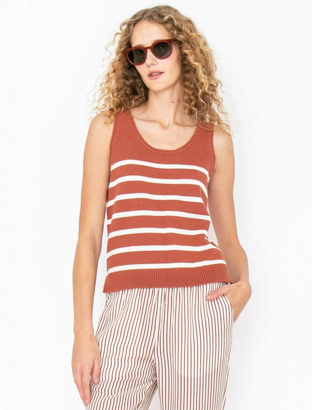 Model wearing KULE's the gio tank in bronze and cream stripe.