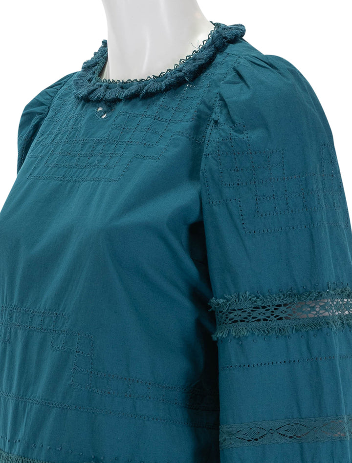 Close-up view of Sea NY's lilith thread pull long sleeve top in deep teal.