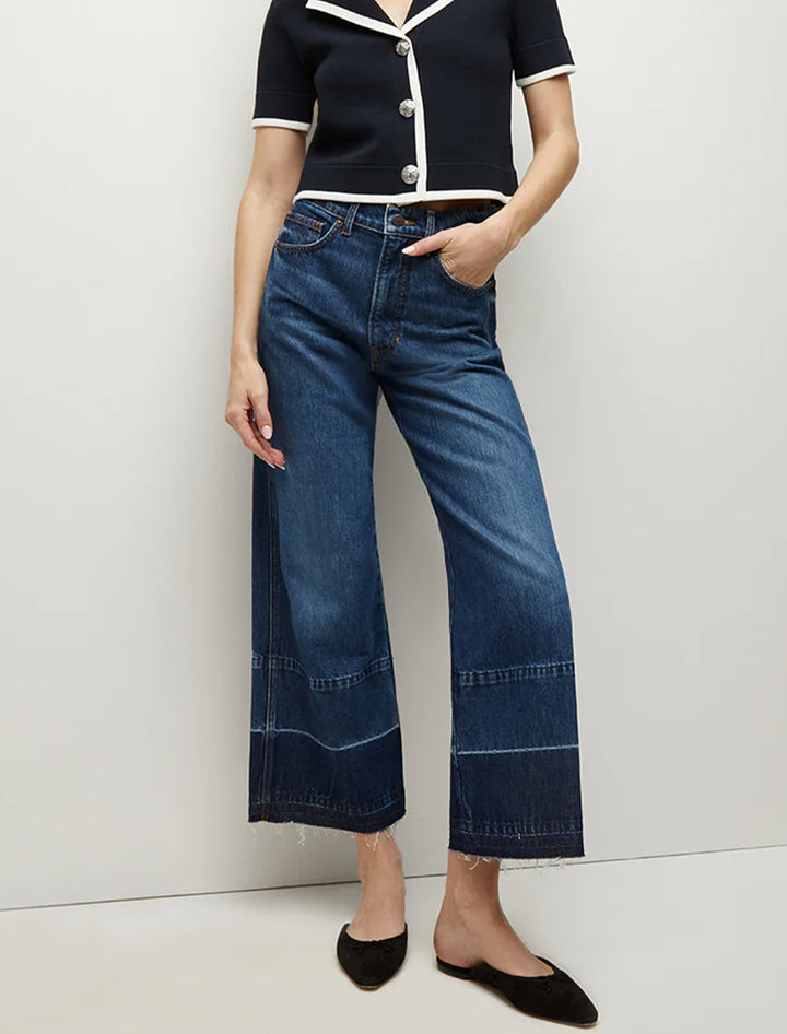 Model wearing Veronica Beard's taylor cropped high rise wide leg jeans in bright blue.