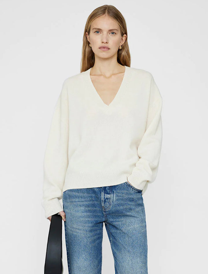 Model wearing Anine Bing's lee sweater in ivory.
