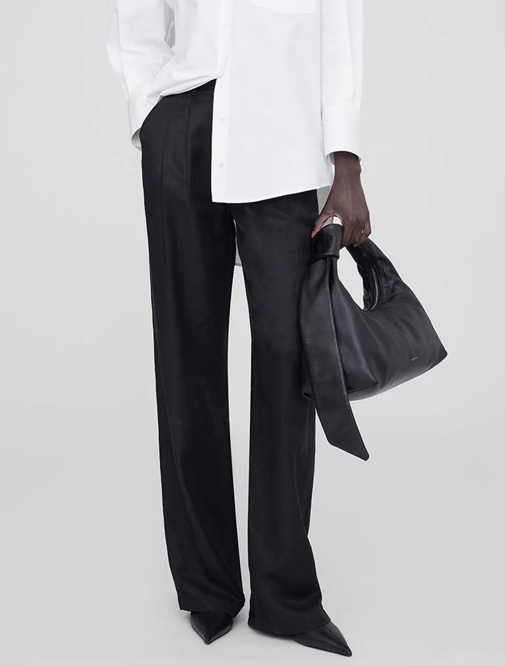 Model holding Anine Bing's grace bag in black.