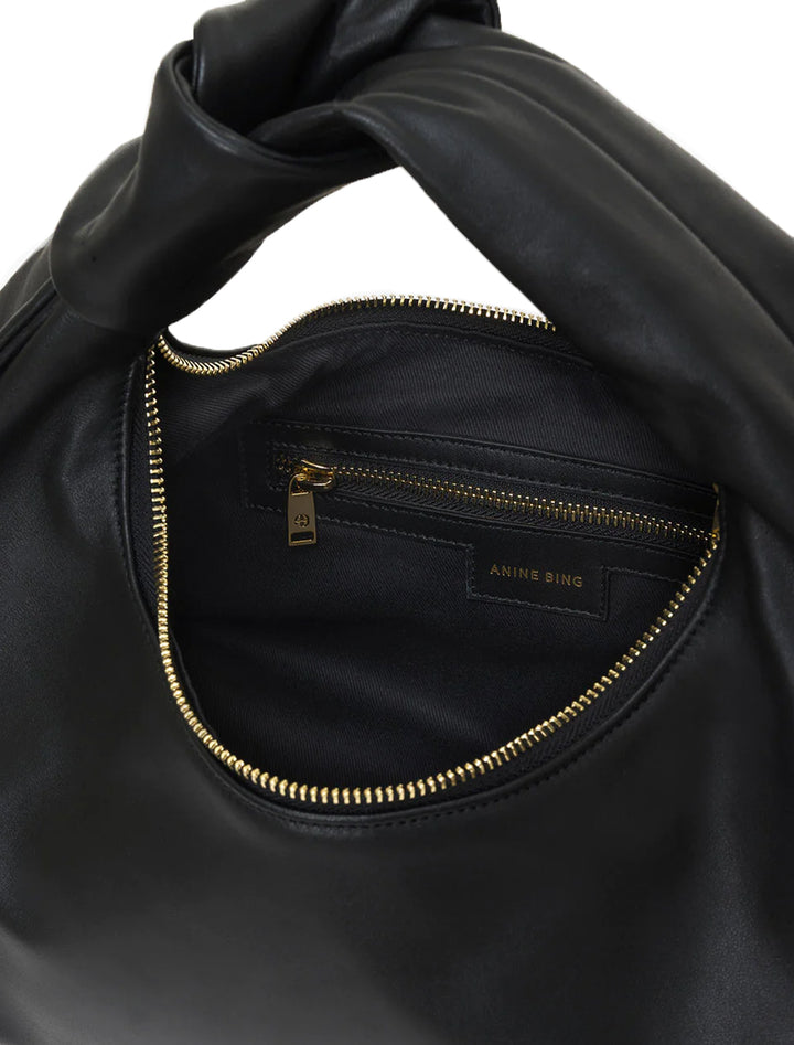 Close-up view of Anine Bing's grace bag in black.