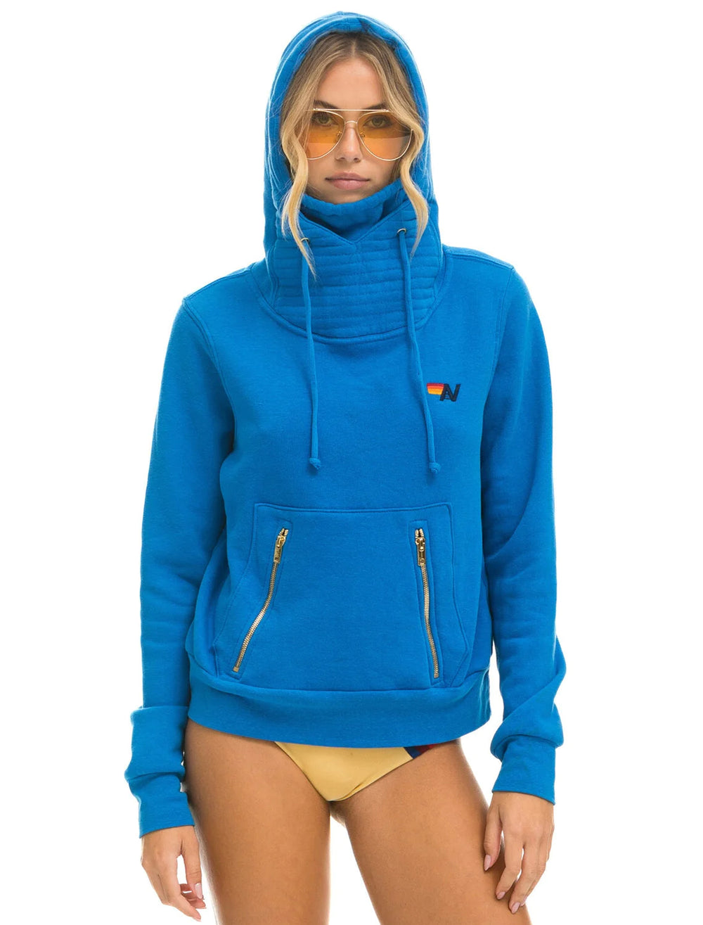 Model wearing Aviator Nation's ninja pullover hoodie in ocean.