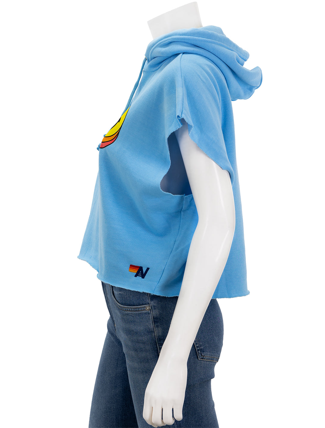 Side view of Aviator Nation's smiley sunset sleeveless cropped pullover hoodie in sky.