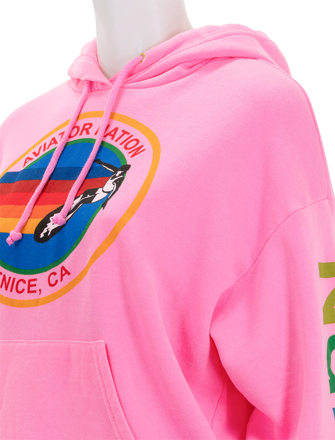 Close-up view of Aviator Nation's pullover hoodie relaxed in neon pink.