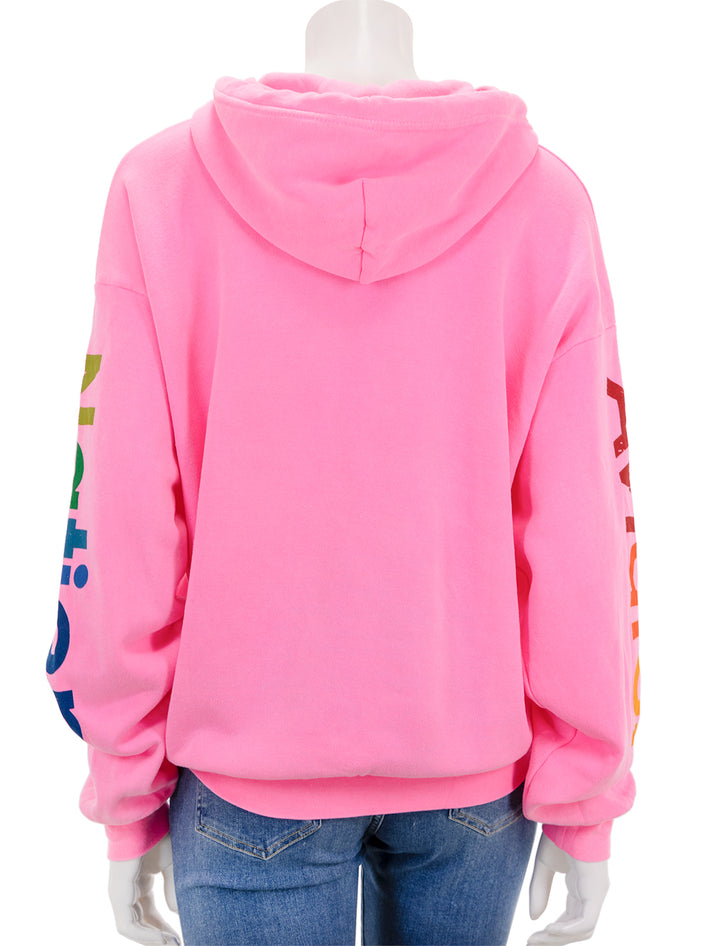 Back view of Aviator Nation's pullover hoodie relaxed in neon pink.