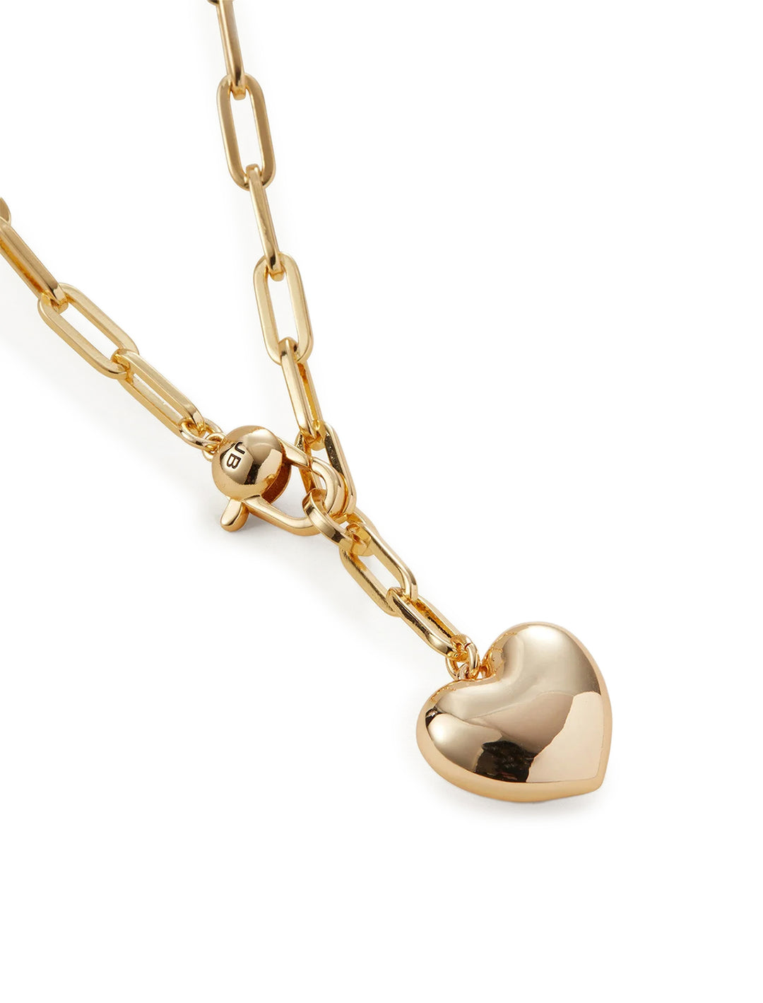 Close-up view of Jenny Bird's puffy heart chain necklace in gold.
