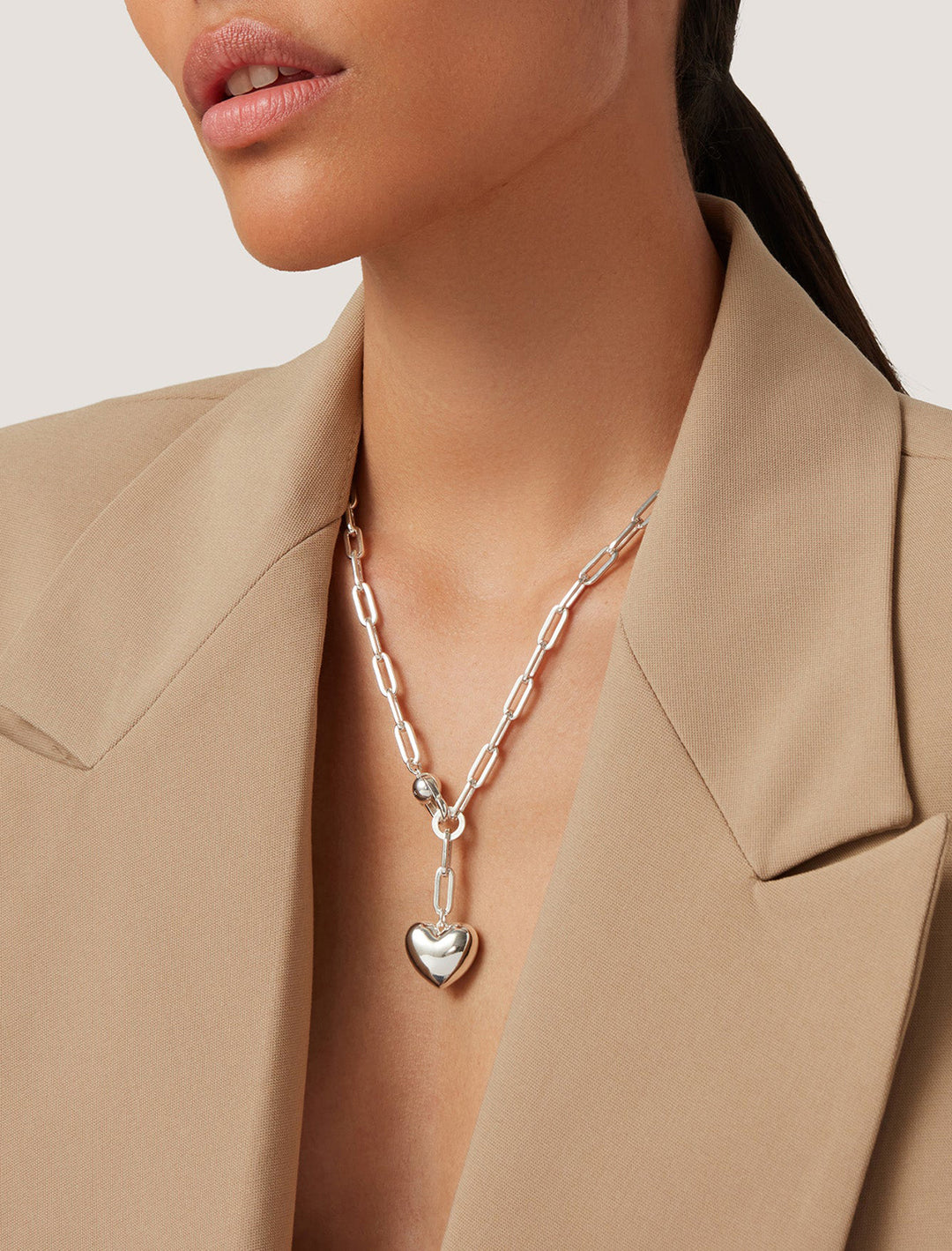 Model wearing Jenny Bird's puffy heart chain necklace in silver.