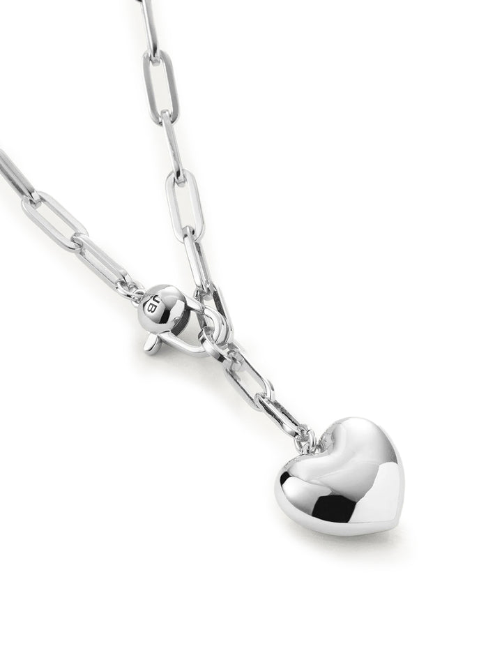 Close-up view of Jenny Bird's puffy heart chain necklace in silver.