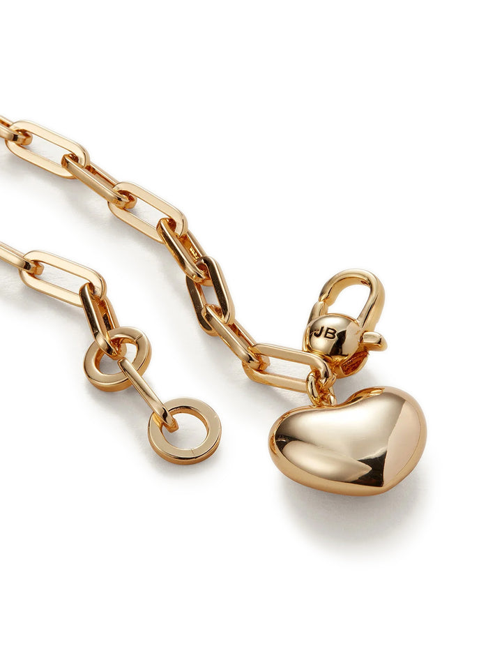 Close-up view of Jenny Bird's puffy heart chain bracelt in gold.