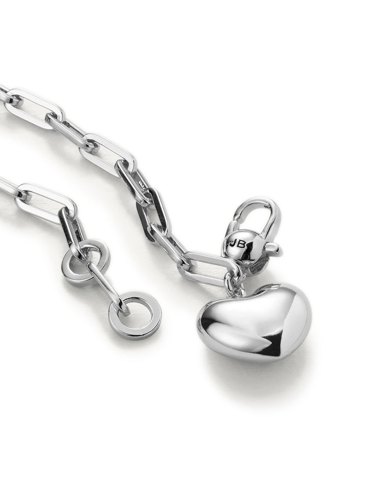 Close-up view of Jenny Bird's puffy heart chain bracelet in silver.