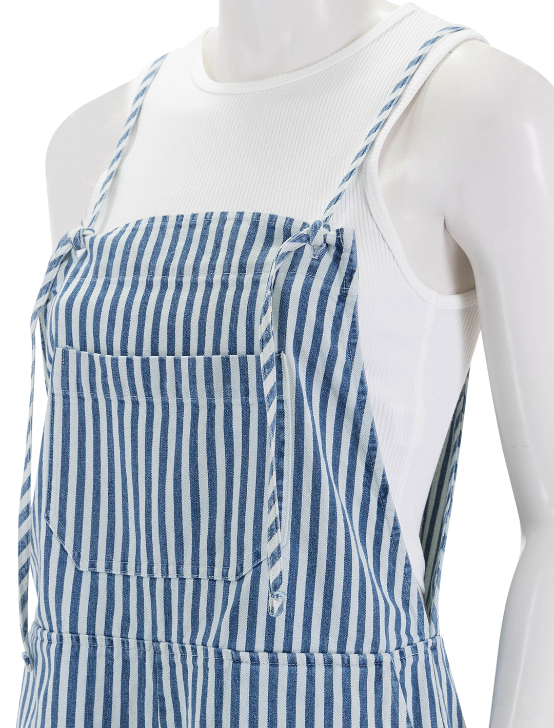 Close-up view of Self Contrast's eleanor romper in wide stripes denim.