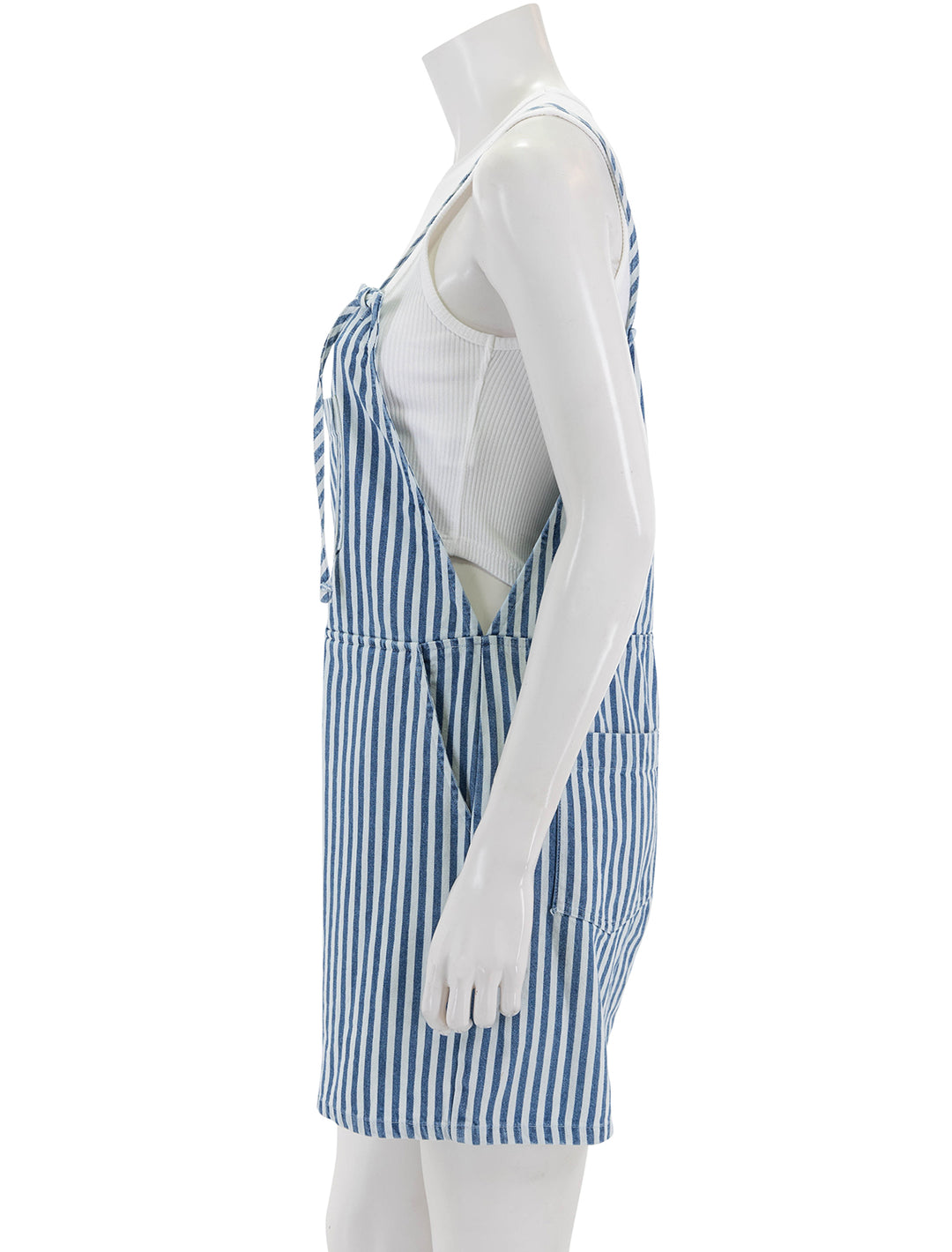 Side view of Self Contrast's eleanor romper in wide stripes denim.