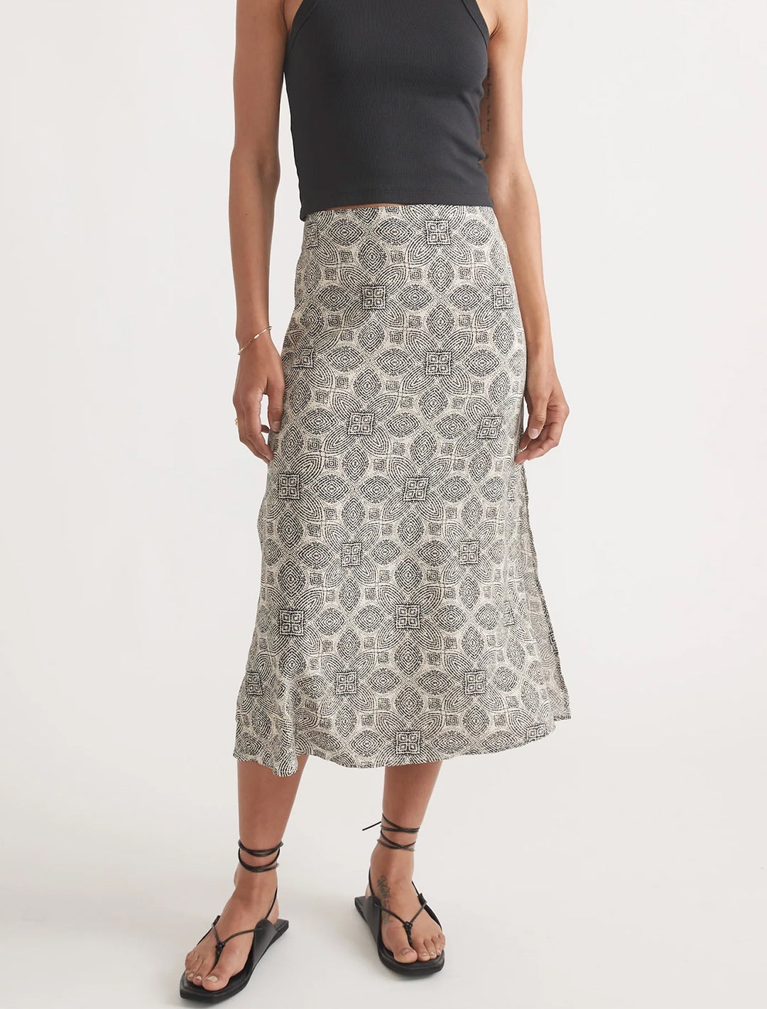 Model wearing Marine Layer's ryan slip skirt in black and white mandala print.