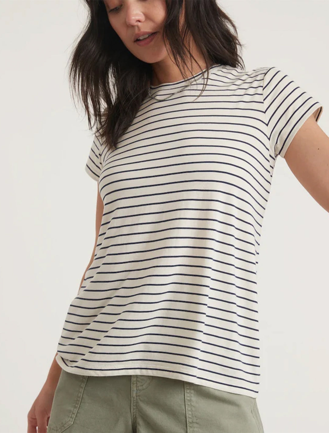 Model wearing Marine Layer's swing crew tee in black and white stripe.