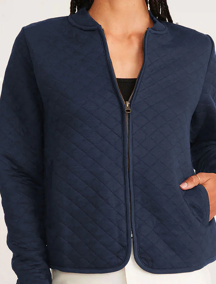 model wearing corbet quilted bomber in navy