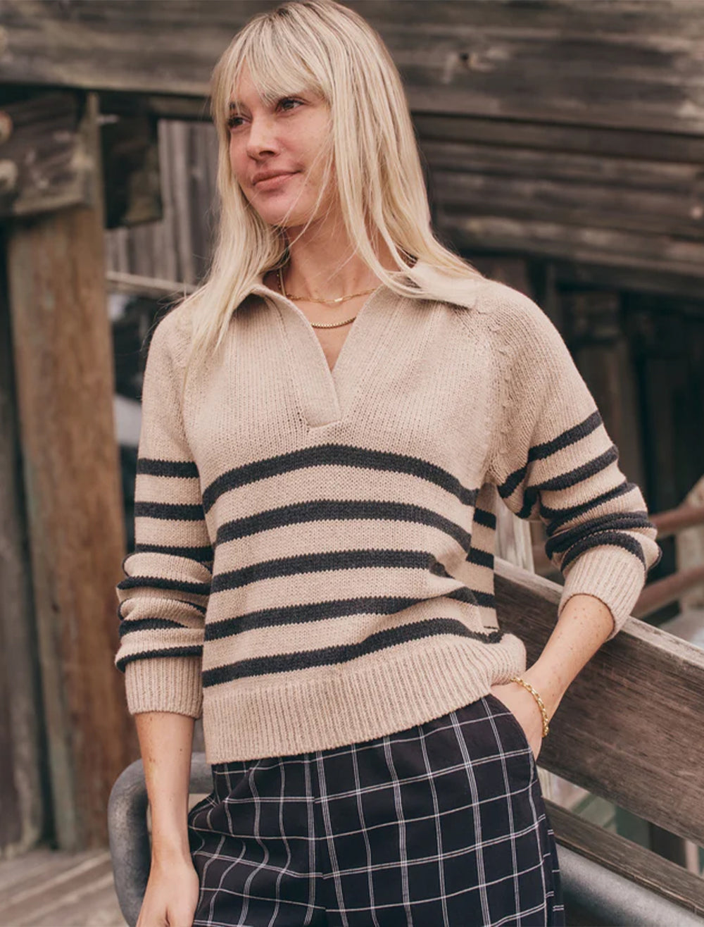 Model wearing Marine Layer's relaxed polo sweater in neutral stripe.