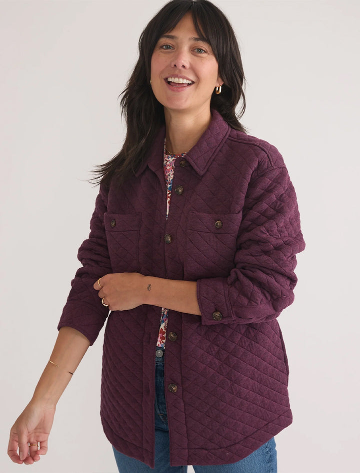 Model wearing Marine Layer's corbet shirt jacket in plum perfect.