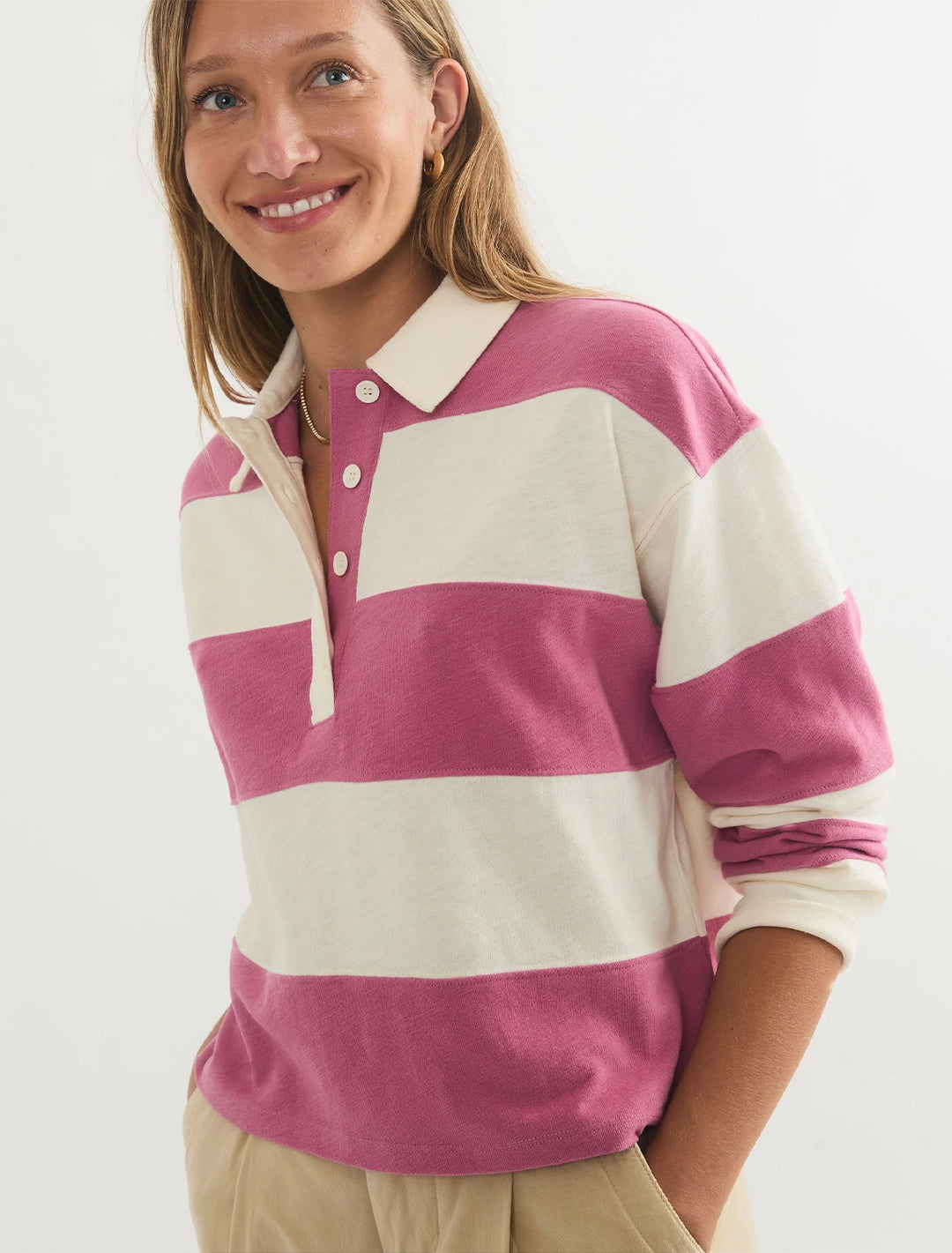 Model wearing Marine Layer's rugby polo in raspberry stripe.