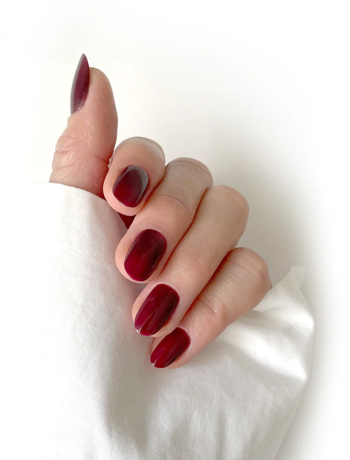 model wearing pomegranate nail polish