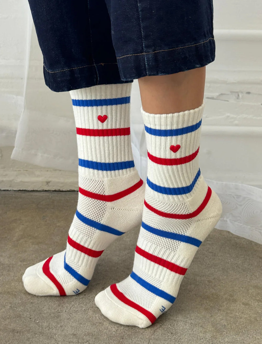 Model wearing Le Bon Shoppe's embroidered heart striped boyfriend socks in leche