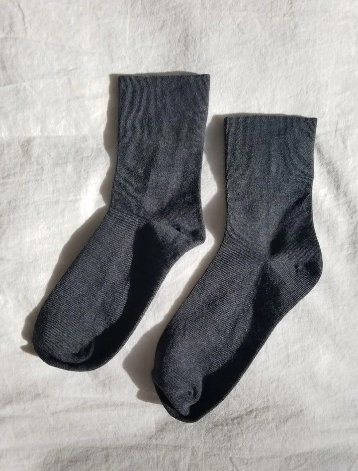 Laydown view of Le Bon Shoppe's sneaker socks in heather black.