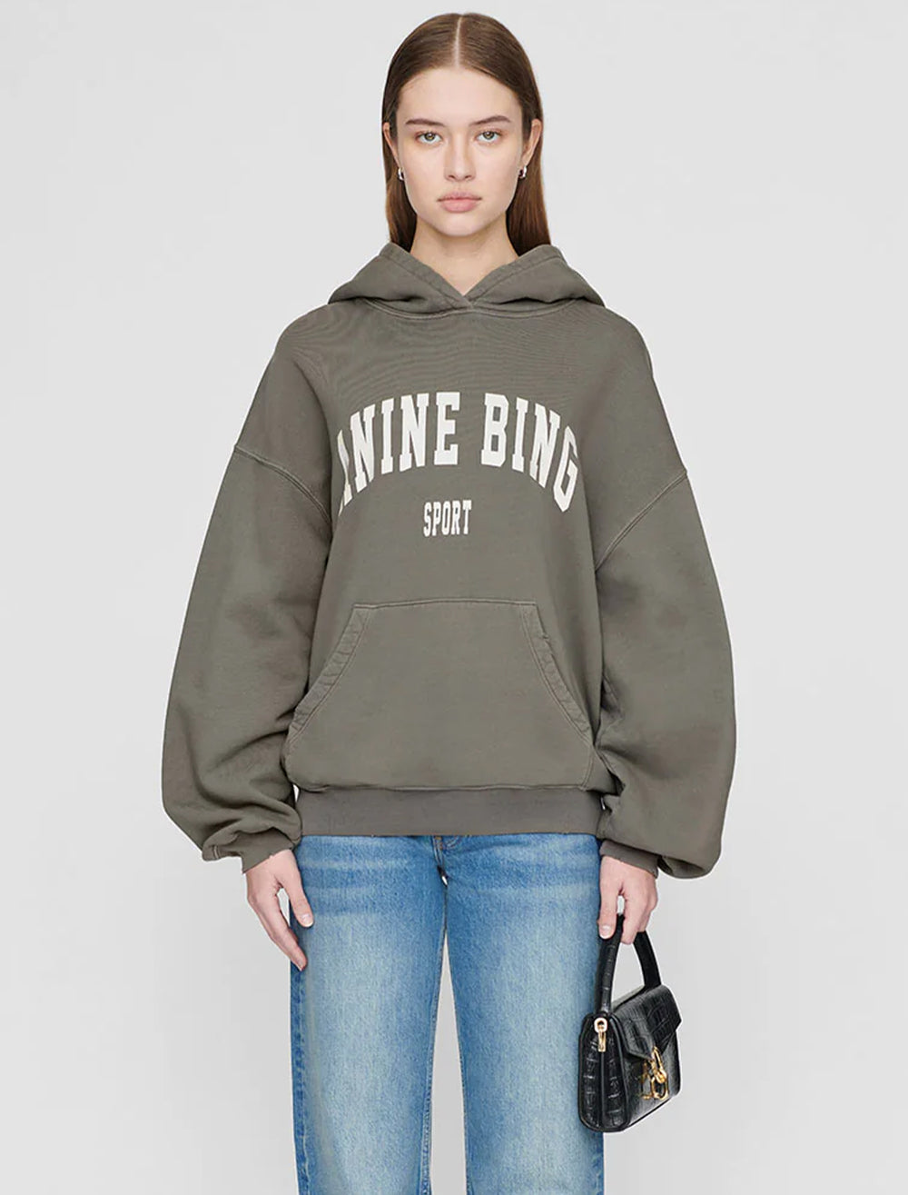 Model wearing Anine Bing's harvey sweatshirt in dusty olive.