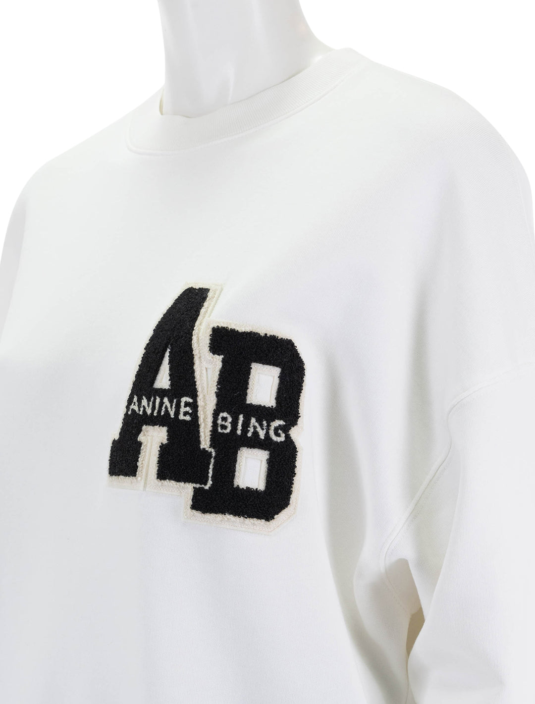 Close-up view of Anine Bing's miles letterman sweatshirt in off white.