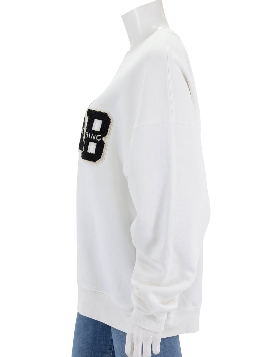 Side view of Anine Bing's miles letterman sweatshirt in off white.