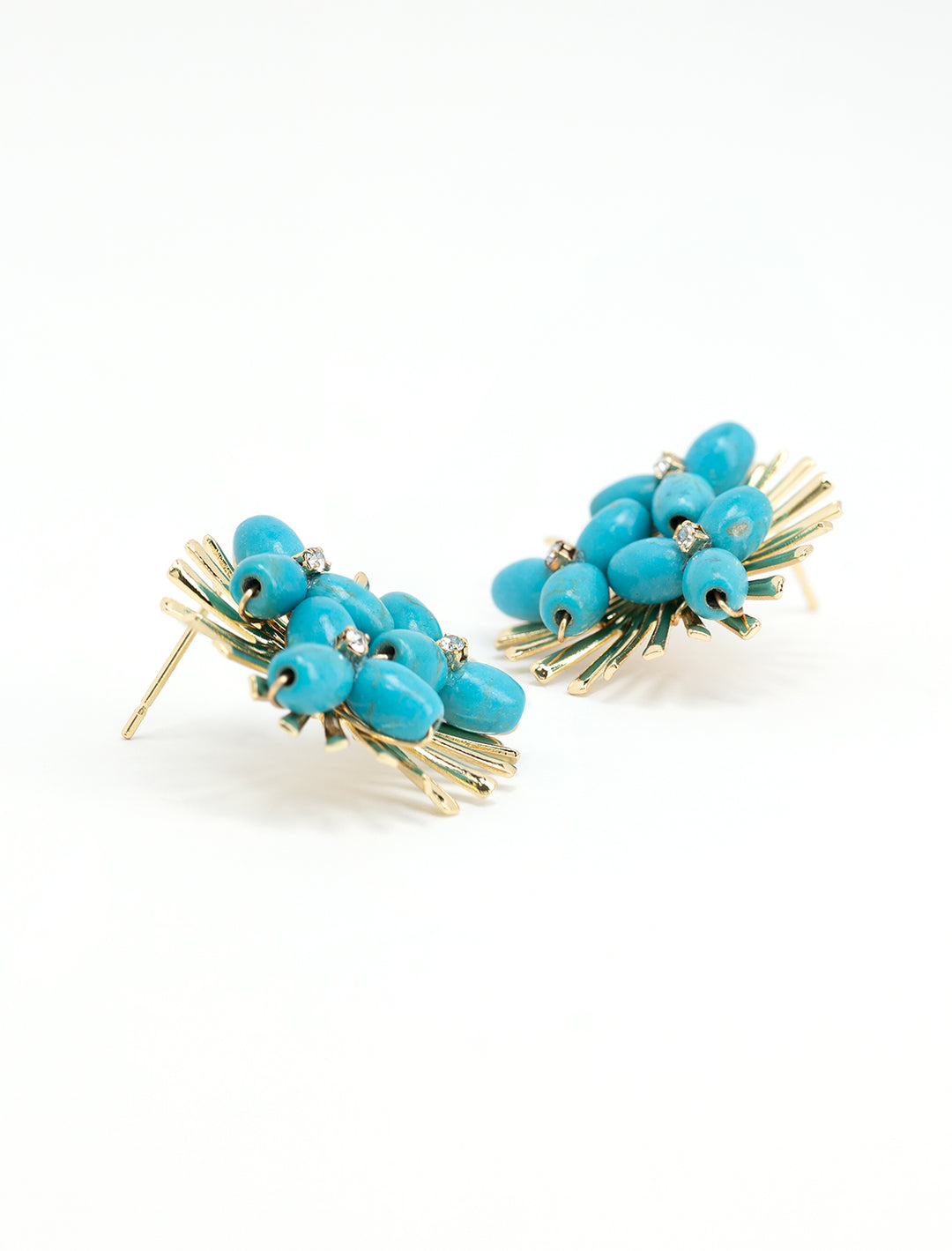 Close-up view of St. Armands' turquoise sunburst statement earring.
