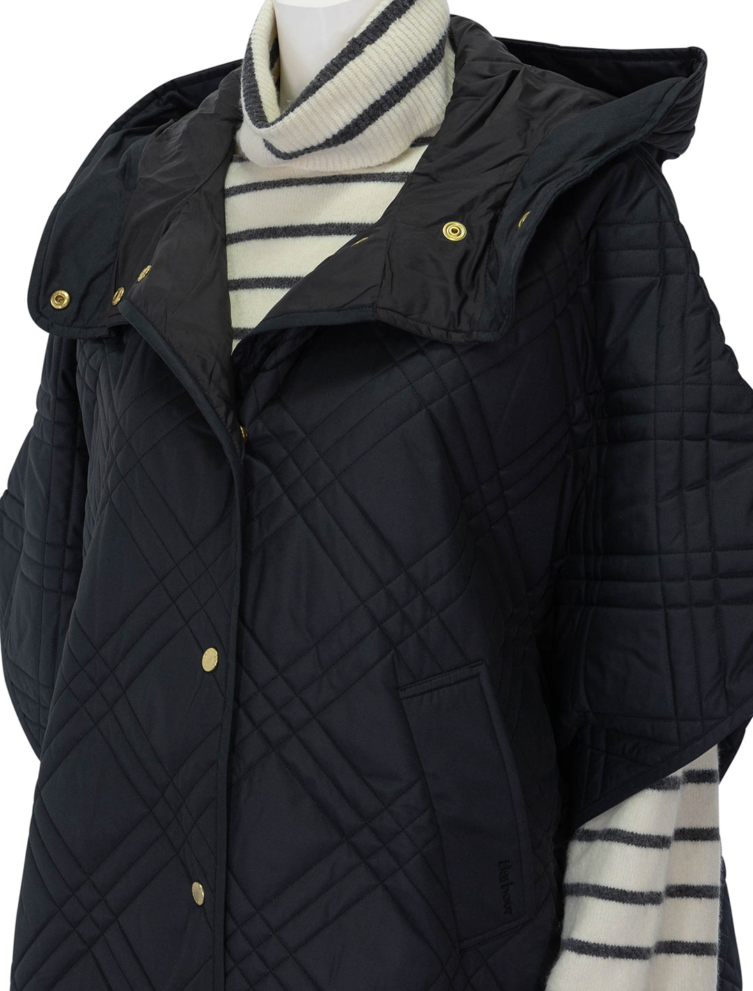 Close-up view of Barbour's astor quilted cape in black.