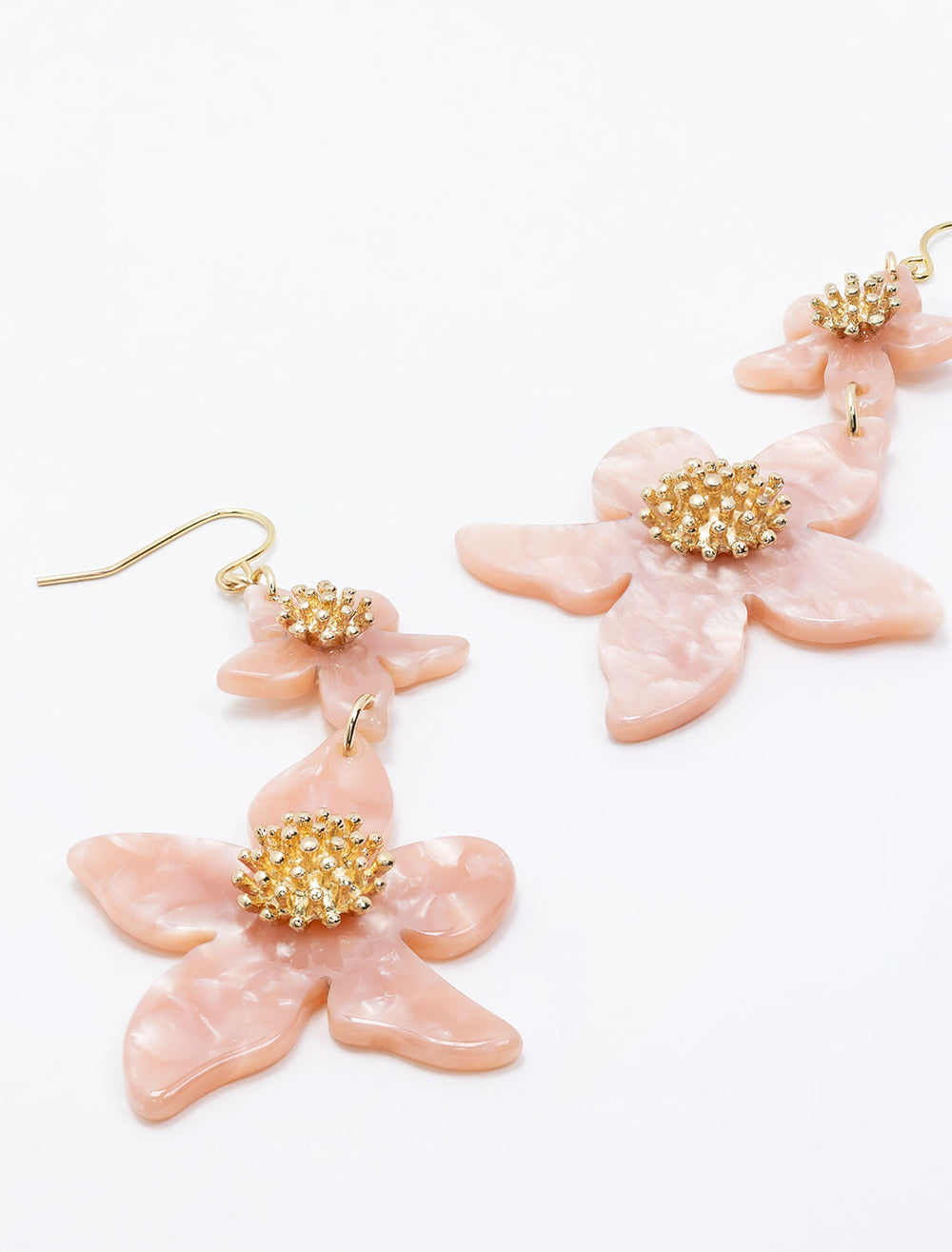 Laydown of West Eleventh's double pink flower statement earrings.