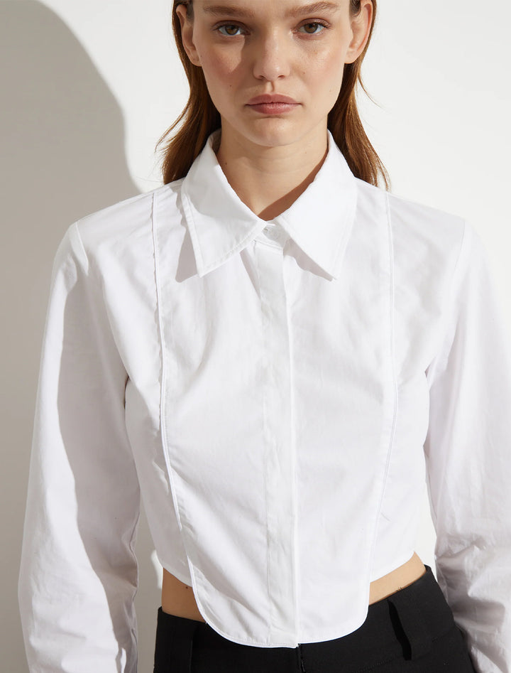 Model wearing Saint Art's joyce tuxedo shirt in white.