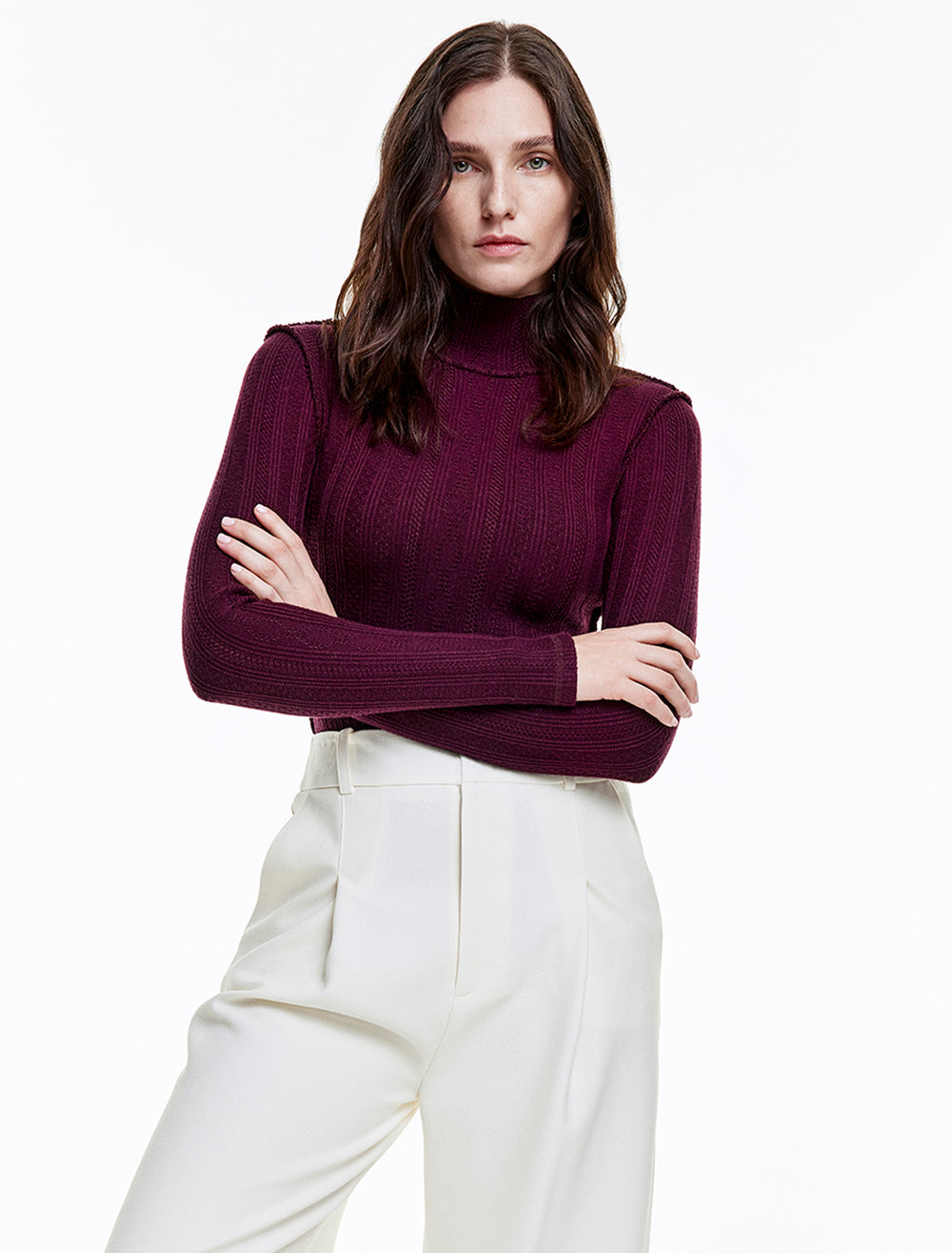 Model wearing Smythe's pointelle turtleneck in plum.