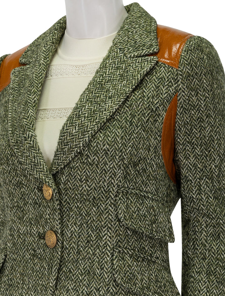 close up view of rifle patch equestrian blazer in moss herringbone