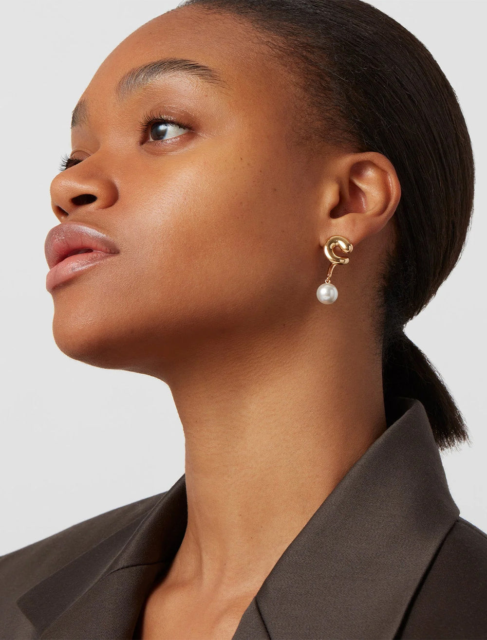 Model wearing Jenny Bird's daphne earring in gold.