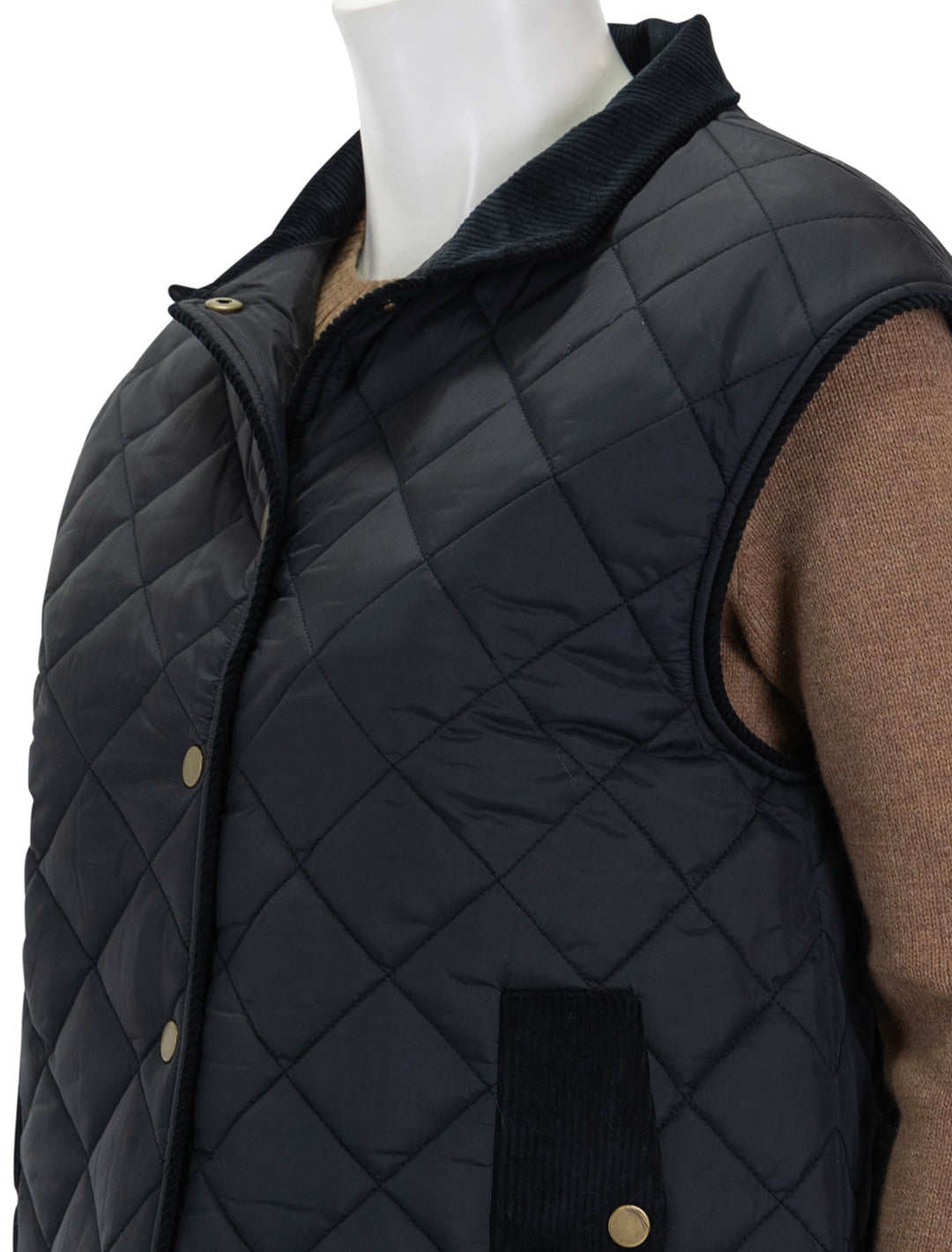 Close-up view of KULE's the rupert quilted vest in black.