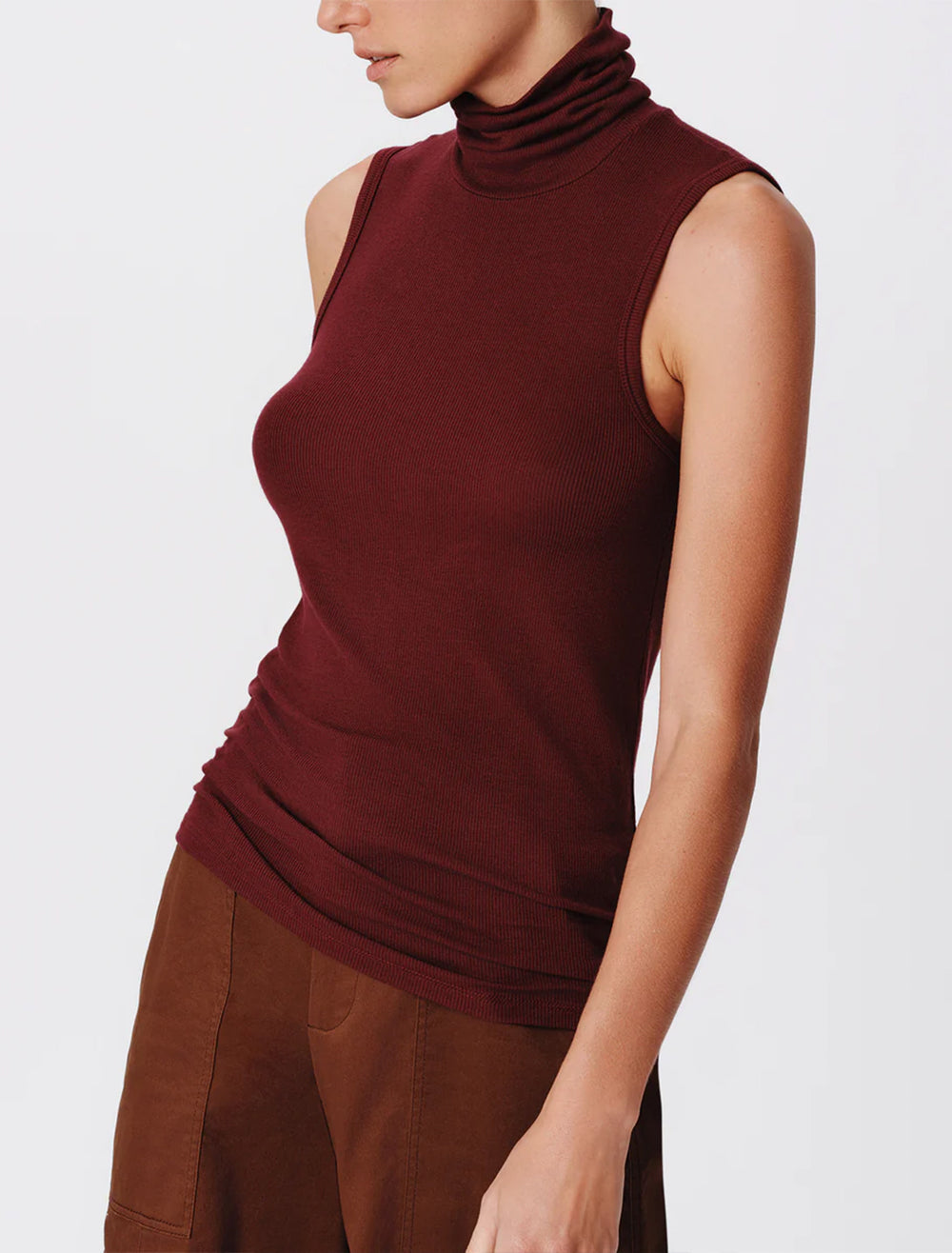 Model wearing ATM's modal sleeveless turtleneck in merlot.