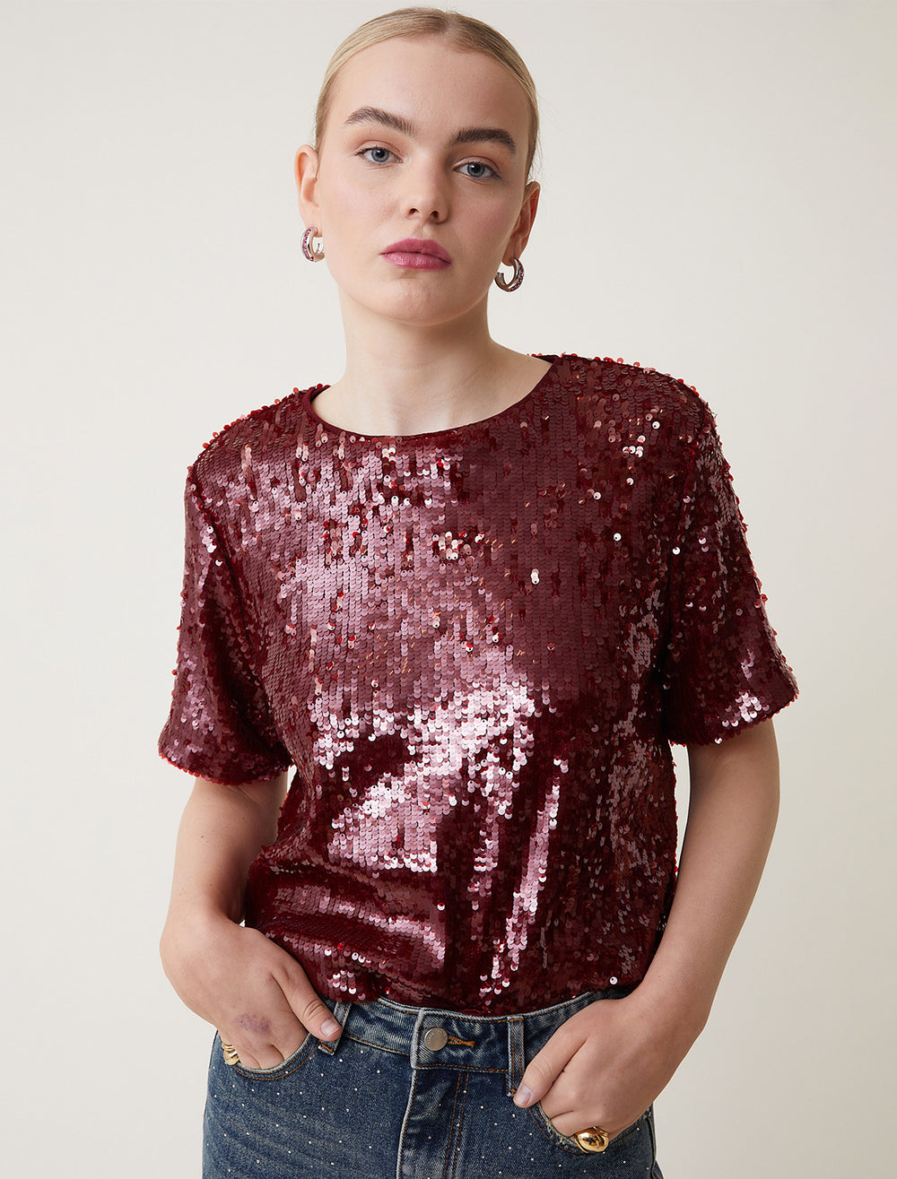 Model wearing Suncoo Paris' Louise Sequin Top in Bordeaux.