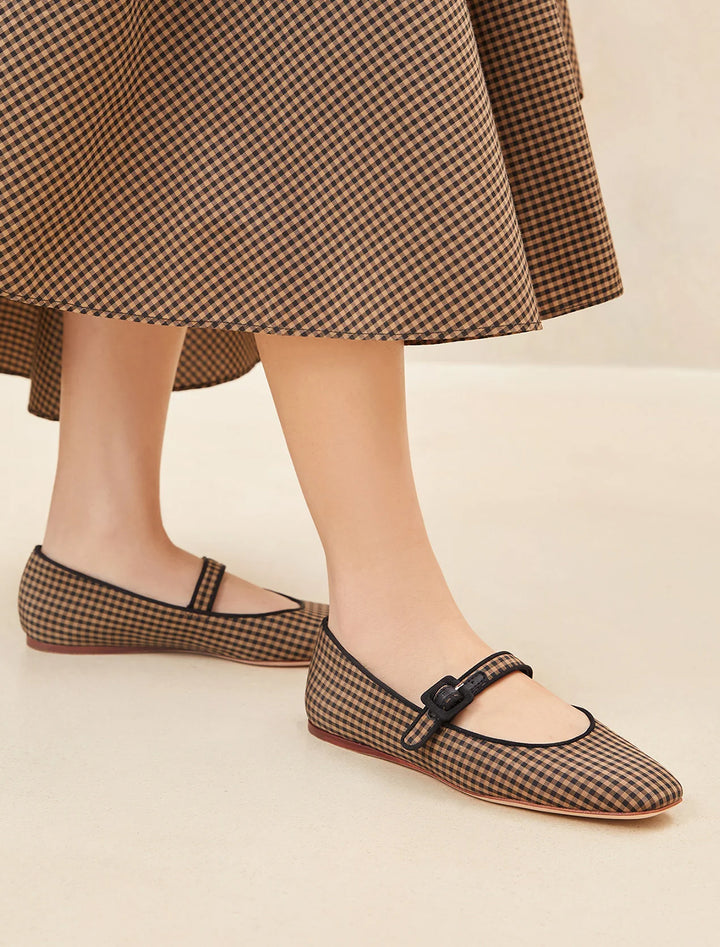 Model wearing Loeffler Randall's ginger in brown and black check.