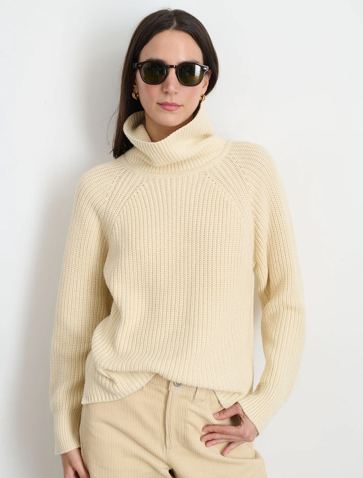 Model wearing Alex Mill's nora turtleneck in cream.