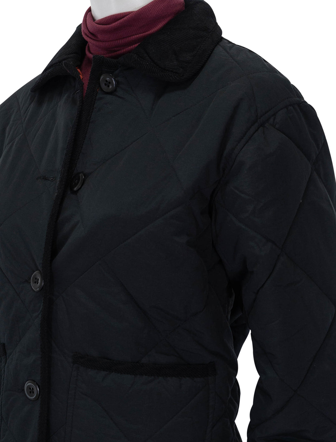 Close-up view of Alex Mill's quinn quilted jacket in black.