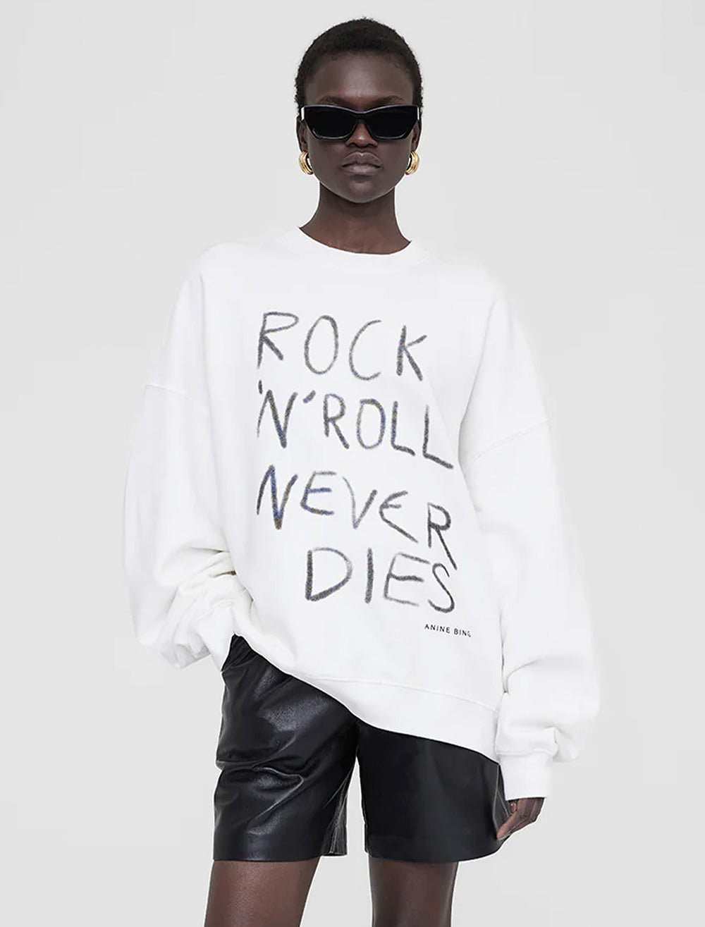Model wearing Anine Bing's rock n roll never dies miles sweatshirt.