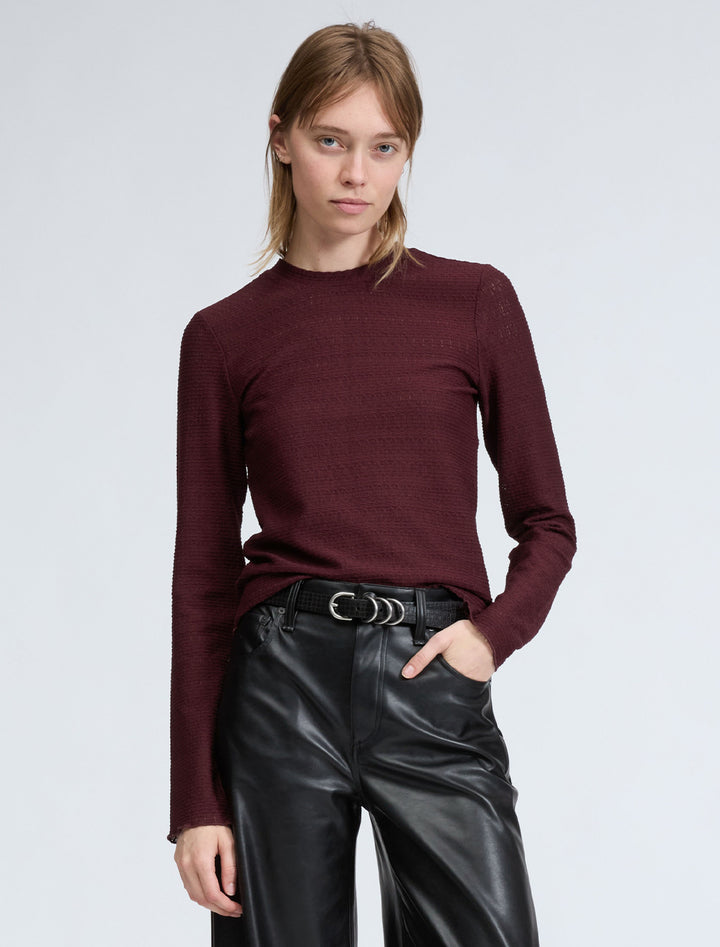 Model wearing Rag & Bone's julia long sleeve knit in dark purple.