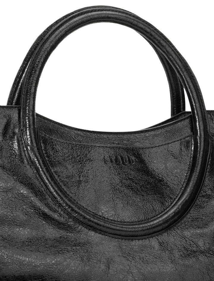 Close-up view of Staud's maude satchel in black.