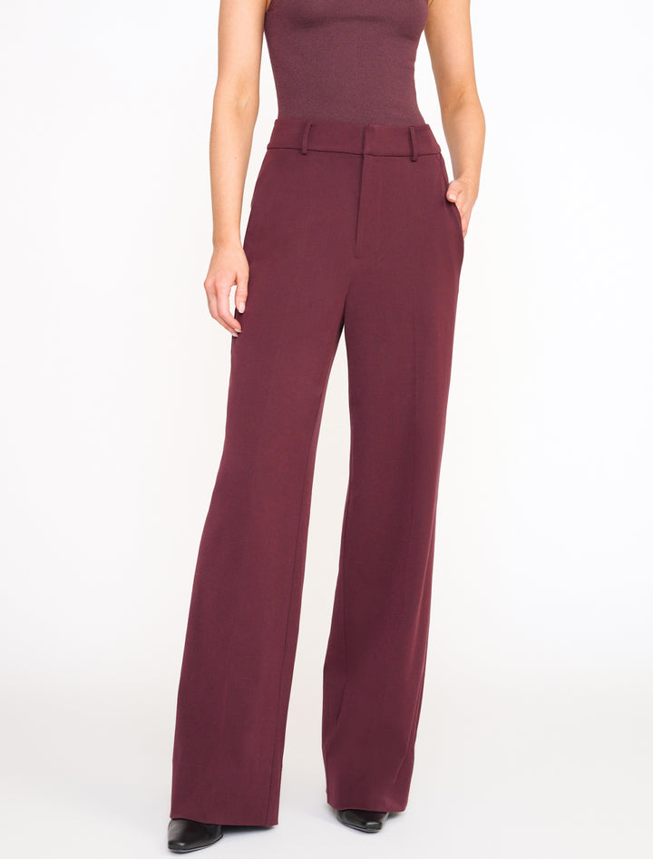 Model wearing STAUD's prince pant in merlot.