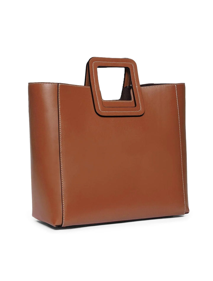 Back angle view of Staud's shirley leather tote bag in tan.