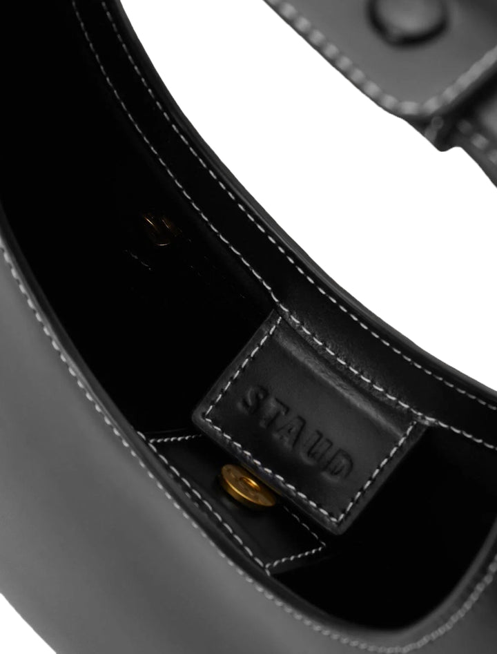 Close-up inside view of Staud's moon tote bag in black.