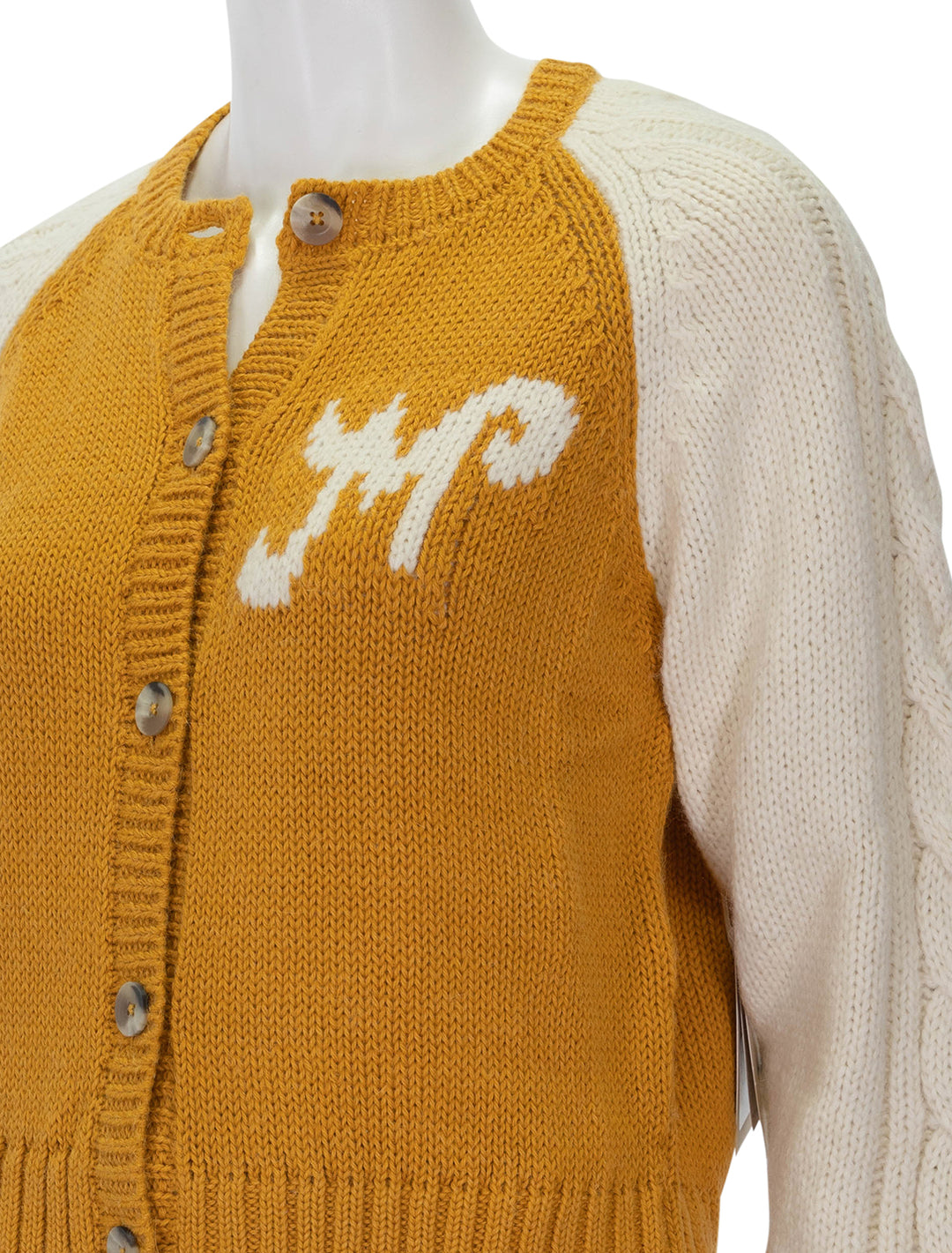 Close-up view of Mother's the concert cardigan.